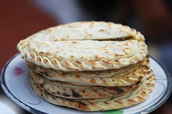 Variety of traditional Hunza Valley foods including Diram Phitti, dried apricots, and local bread.